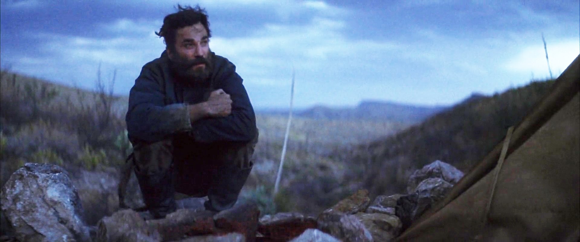 Daniel Plainview Sitting at a fire near mineshaft