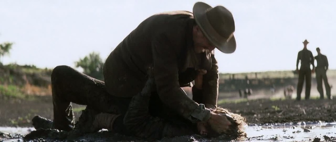 Daniel slaps Eli around in the mud
